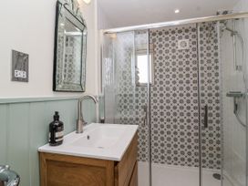 A bathroom with a sink and shower at The Little Loft in Burford