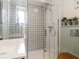 A bathroom with a shower and sink at The Little Loft in Burford