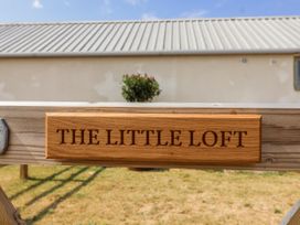 A wooden sign with the name The Little Loft at The Little Loft in Burford
