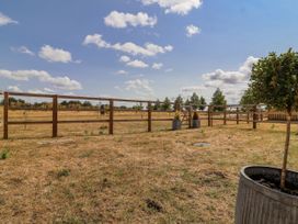 An outdoor area with a wooden fence and a small tree at The Little Loft in Burford
