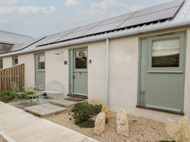 An outdoor area with a door and table at The Little Loft in Burford