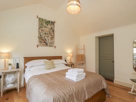 A bedroom with a bed and decorative items at The Little Loft in Burford