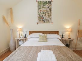 A bedroom with a bed and decorative items at The Little Loft in Burford