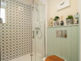 A bathroom with a shower and toilet at The Little Loft in Burford