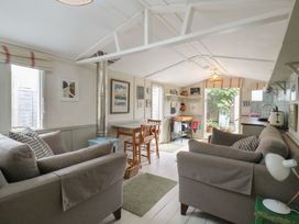 A living room with a sofa, table and chairs at The Artist's Cabin By The Sea in Herne Bay