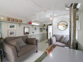 A living room with two sofas and wall art at The Artist's Cabin By The Sea in Herne Bay