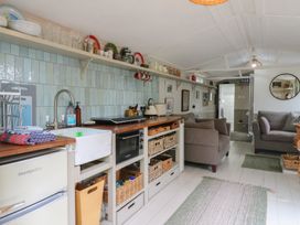 A kitchen with sink and seating area at The Artist's Cabin By The Sea in Herne Bay