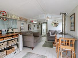 A living room with a sofa and table at The Artist's Cabin By The Sea Herne Bay