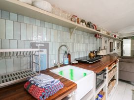 A kitchen with a wooden countertop and dish rack at The Artist's Cabin By The Sea in Herne Bay