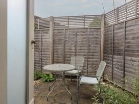 A garden with a table and chairs at The Artist's Cabin By The Sea, Herne Bay