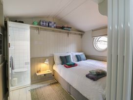 A bedroom with a bed and shower area at The Artist's Cabin By The Sea in Herne Bay