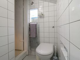 A bathroom with a toilet and towel rack at The Artist's Cabin By The Sea Herne Bay