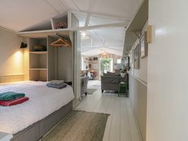 A bedroom with a bed and seating area at The Artist's Cabin By The Sea Herne Bay