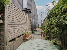 A garden with a wooden fence and plants at The Artist's Cabin By The Sea in Herne Bay