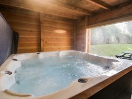 A hot tub in a wooden spa room at The Bevan in Bontnewydd, Gwynedd