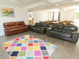 A living room with sofas and a colorful rug at The Bevan in Bontnewydd, Gwynedd
