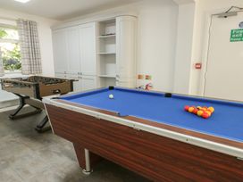 A game room with a pool table and foosball table at The Bevan in Bontnewydd, Gwynedd