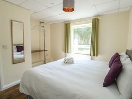 A bedroom with a bed and a window at The Bevan in Bontnewydd, Gwynedd