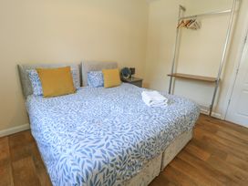 A bedroom with a bed and a clothes hanger at The Bevan, Bontnewydd, Gwynedd