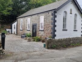 An outdoor view of a building with a pathway at The Old Nant-y-Fflint Chapel Pentre Halkyn near Holywell