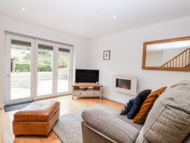 A living room with a sofa and television at Mariners Rest in Gorran Haven