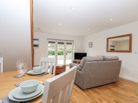 A living room with a sofa and television at Mariners Rest in Gorran Haven