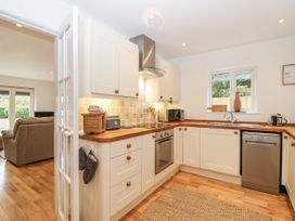 A kitchen with appliances and wooden countertops at Mariners Rest in Gorran Haven