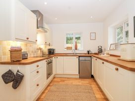 A kitchen with appliances and wooden countertops at Mariners Rest in Gorran Haven