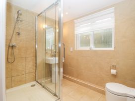 A bathroom with a shower, toilet, and sink at Mariners Rest in Gorran Haven