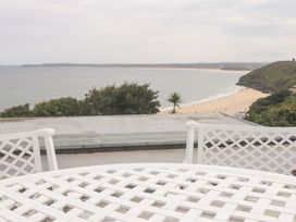 A view of the ocean and beach from a terrace at Flat 2, Moonrakers in St. Ives