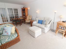 A living room with a sofa and dining table at Flat 2, Moonrakers in St. Ives
