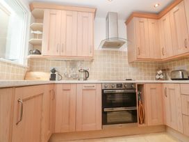 A kitchen with cabinets and appliances at Flat 2, Moonrakers in St. Ives