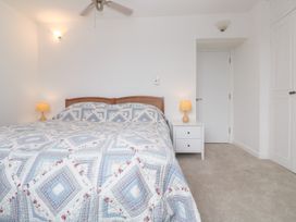 A bedroom with a bed and bedside table at Flat 2, Moonrakers in St. Ives