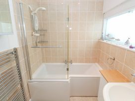 A bathroom with a bathtub and shower at Flat 2, Moonrakers in St. Ives