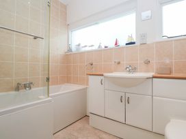 A bathroom with a bathtub and sink at Flat 2, Moonrakers in St. Ives