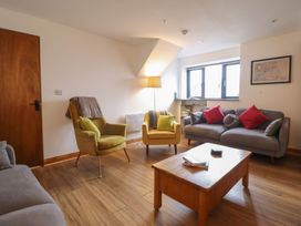A living room with armchairs and a coffee table at The Granary in Welshpool