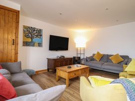 A living room with sofas and a television at The Granary in Welshpool