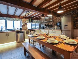 A kitchen with a dining table and chairs at The Granary in Welshpool