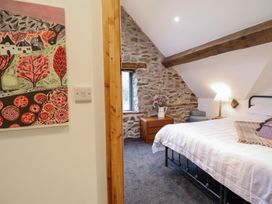A bedroom with a bed and a nightstand at The Granary in Welshpool