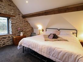 A bedroom with a bed and nightstand at The Granary in Welshpool