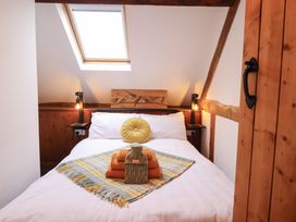 A bedroom with a bed and window at The Granary in Welshpool