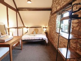 A bedroom with a bed and table at The Granary Welshpool