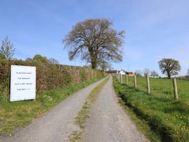 A road leading to Glascoed Farm with a sign at The Granary in Llangyniew near Llanfair Caereinion