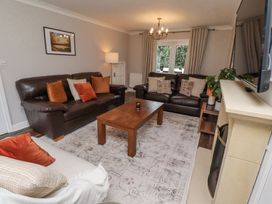 A living room with two brown leather sofas a beige sofa and a wooden coffee table at Sparrow House in Alnwick