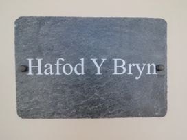 A slate sign with the text Hafod Y Bryn at Hafod Y Bryn Harlech