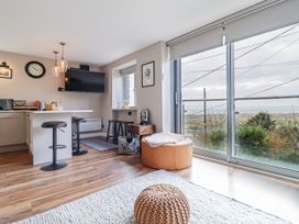 A living room with a kitchen area and a view at Hafod Y Bryn in Harlech