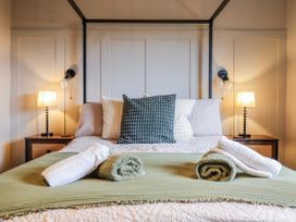 A bedroom with a bed and nightstands at Hafod Y Bryn Harlech
