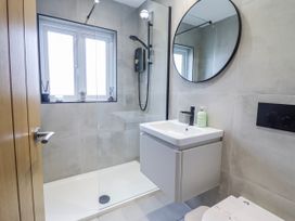 A bathroom with a shower, sink, and toilet at Hafod Y Bryn in Harlech