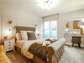 A bedroom with a bed and nightstand at Hafod Y Bryn in Harlech