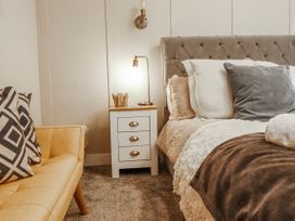 A bedroom with a bed and nightstand at Hafod Y Bryn in Harlech